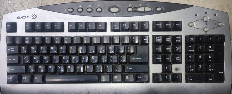 کیبورد سیمی نقرهای مادیران مدل K9816 با اتصال PS2 استوک